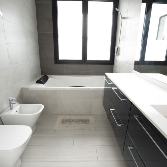 a bathroom with a tub toilet and sink