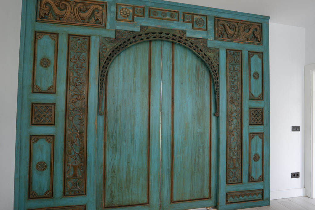 a blue door with carved designs