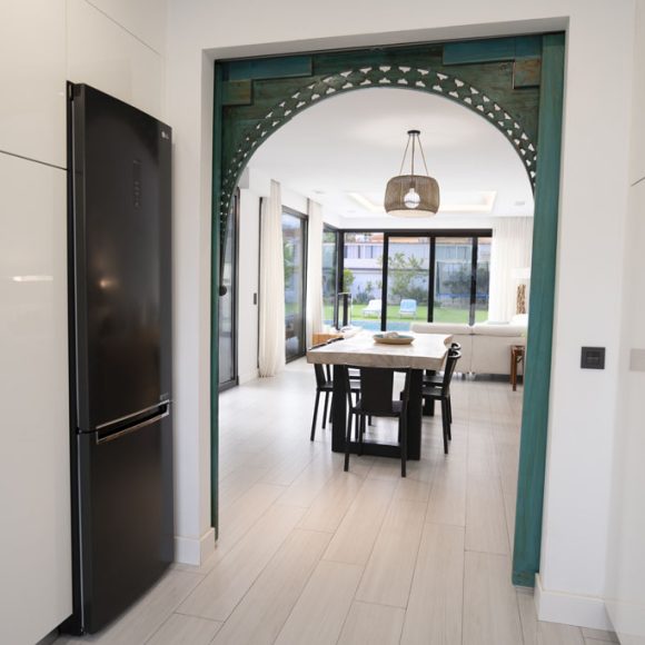 a dining room with a black refrigerator and a table