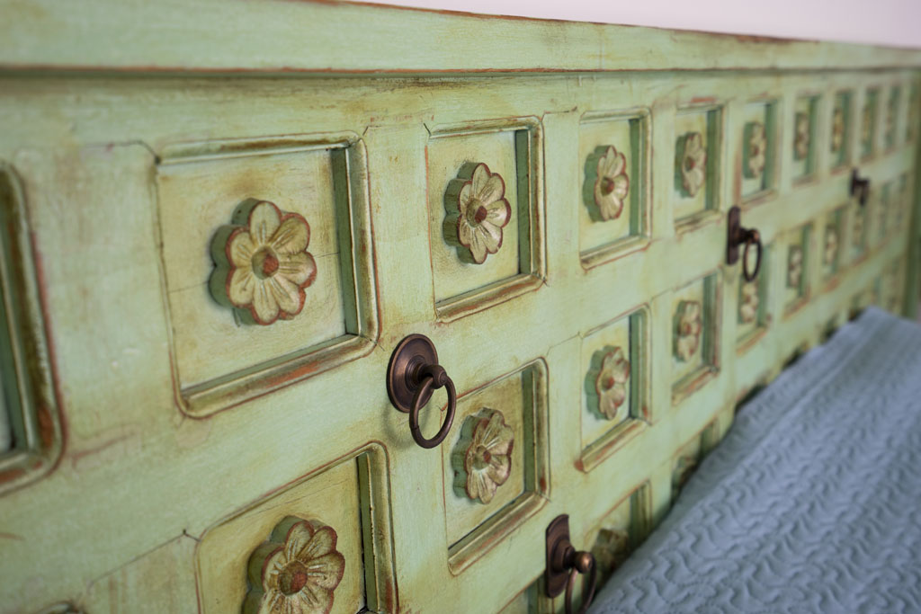 a close up of a green dresser