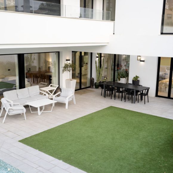 a patio with a table and chairs