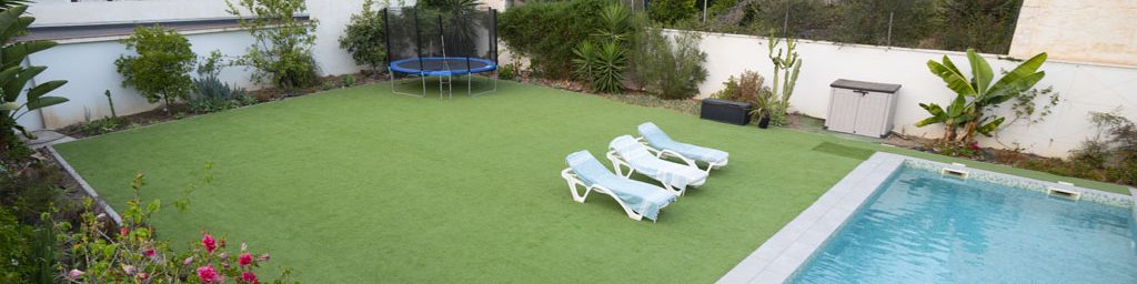 a pool and chairs in a backyard